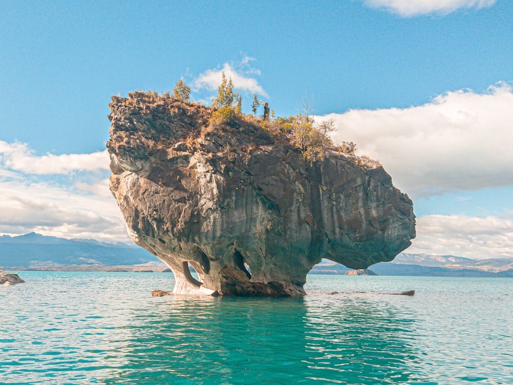 a large rock in the water