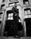 A well-dressed man confidently walking down a city street in stylish attire.