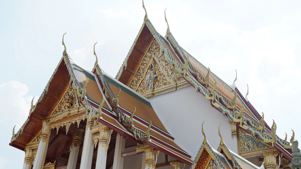 Temple with two distinctively designed roofs, one white and one brown in intricate patterns