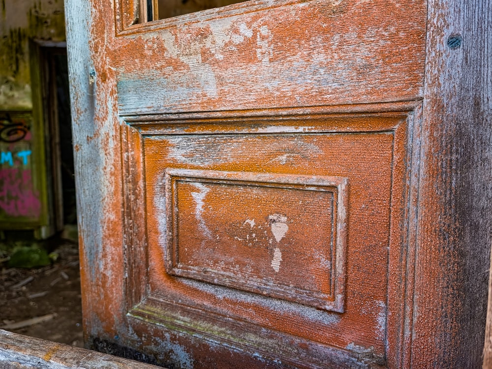 a wooden door with a white cross on it