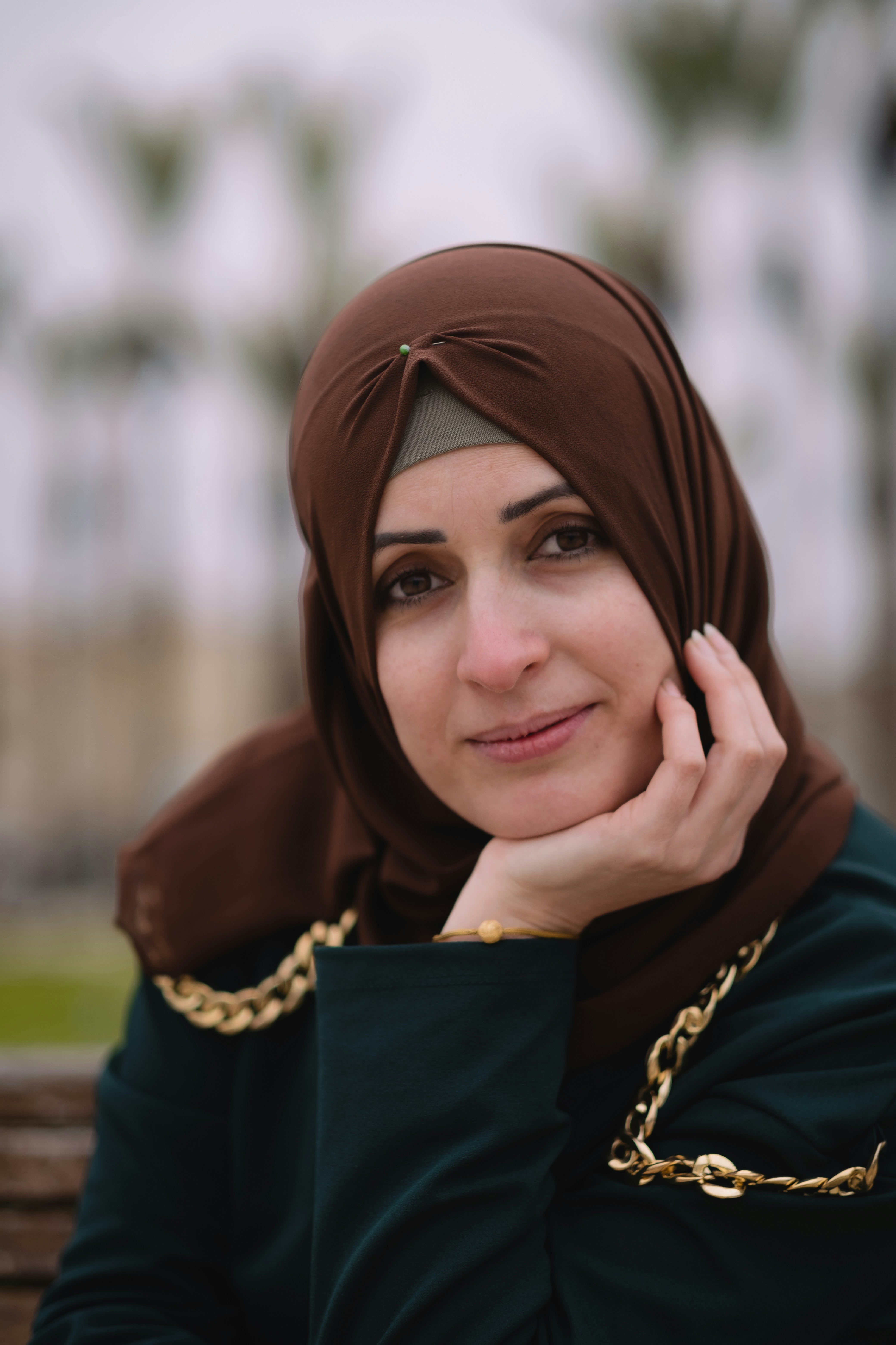 Portrait of Rashidat Ibrahim, RIIB founder, wearing elegant cream hijab with gold embroidery and warm smile