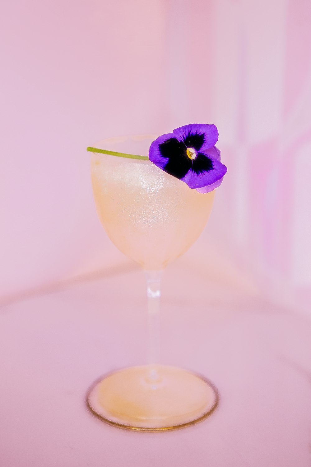 a glass with a flower in it
