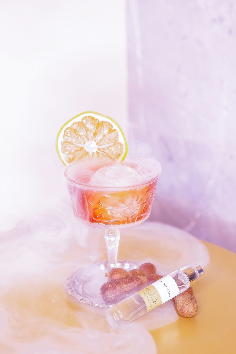 a glass with a drink and a lemon slice on top