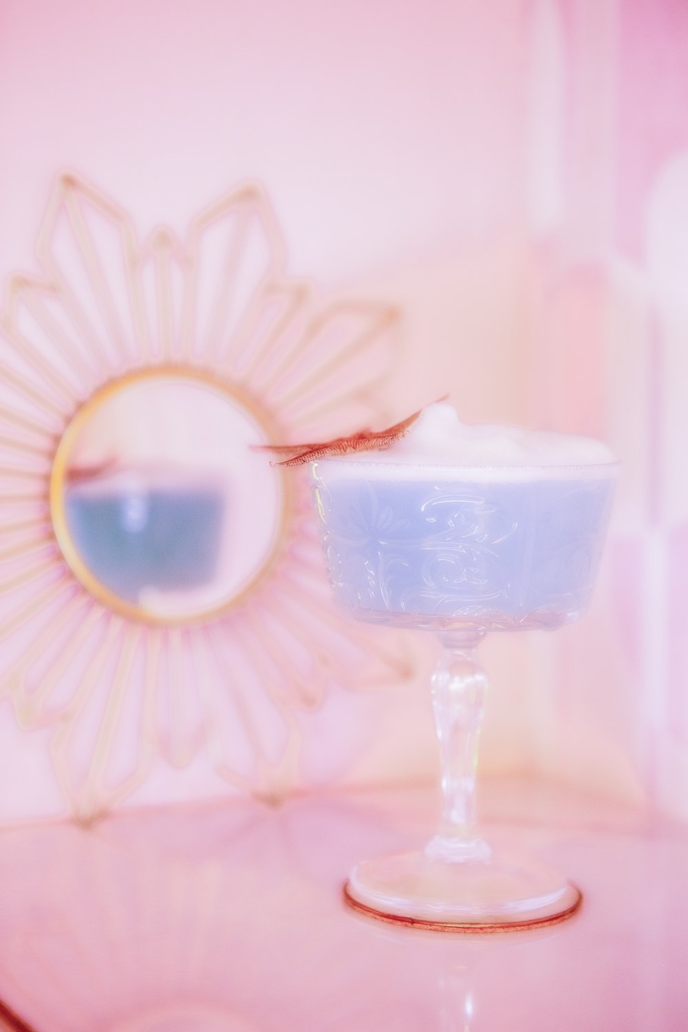 a glass with a straw and a glass with ice cream in it