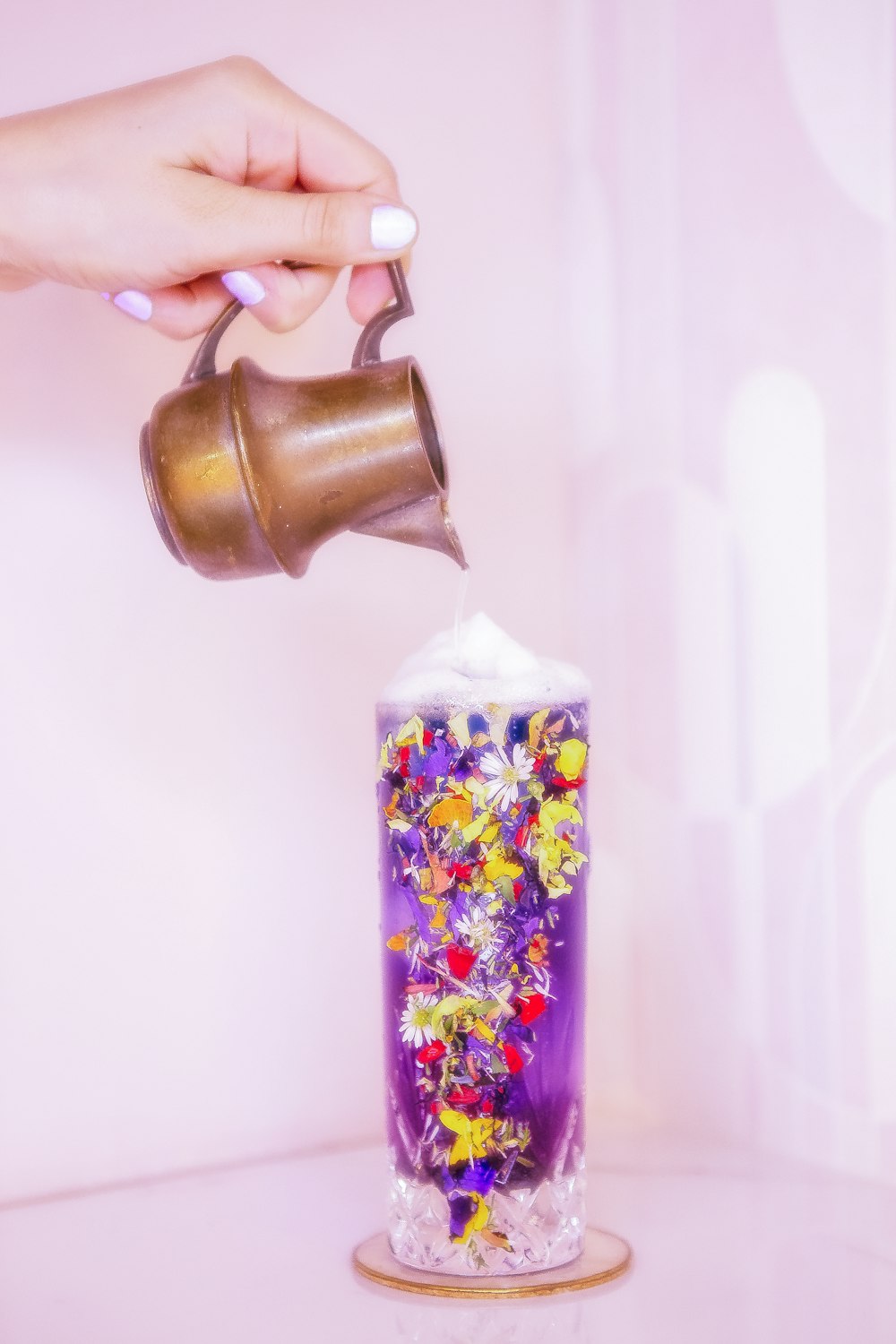 a hand holding a jar of jam