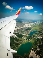 an airplane wing with a river below