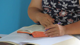 a person writing on a book