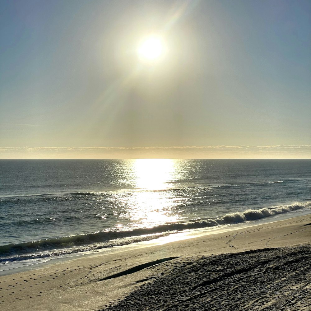 a beach with the sun shining