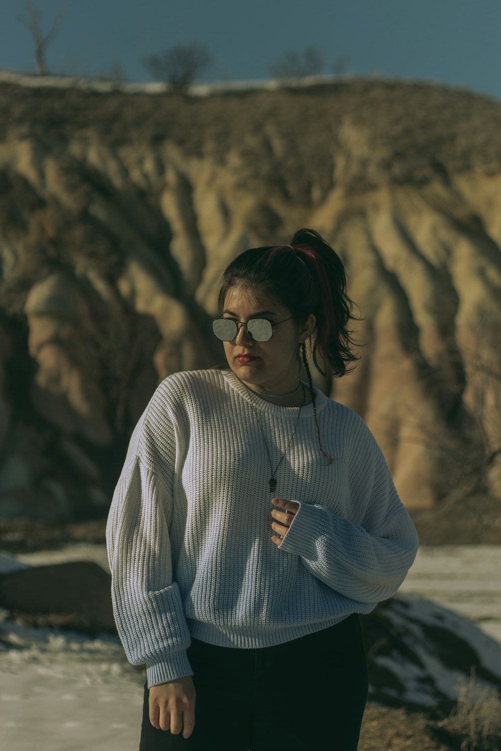 a person standing in front of a rock cliff