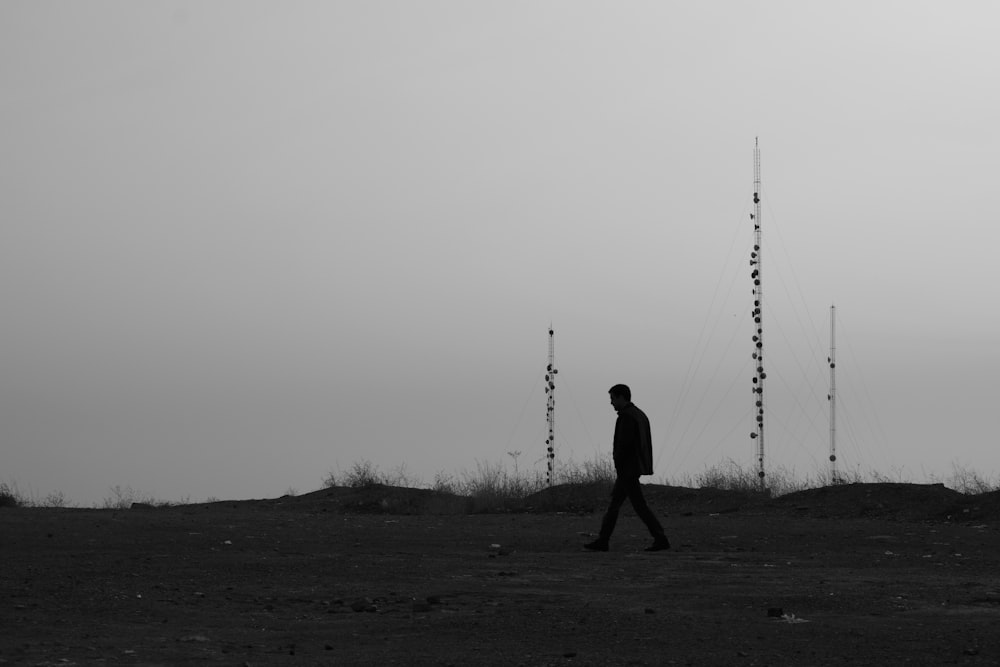 a man walking on a dirt road