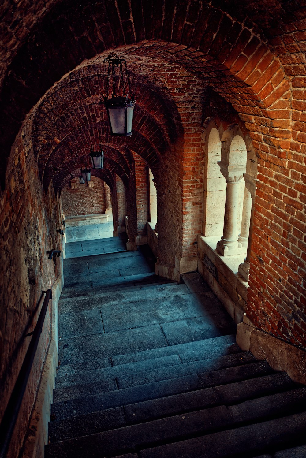 a stone staircase in a brick building
