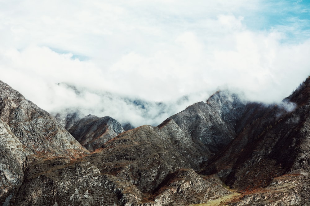 a rocky mountain with clouds