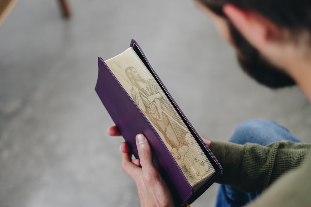 a person holding a purple book