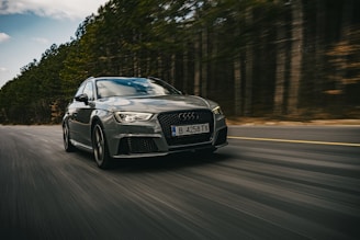 A powerful car in motion on a scenic road.
