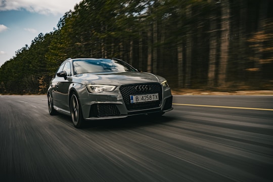 A powerful car in motion on a scenic road.