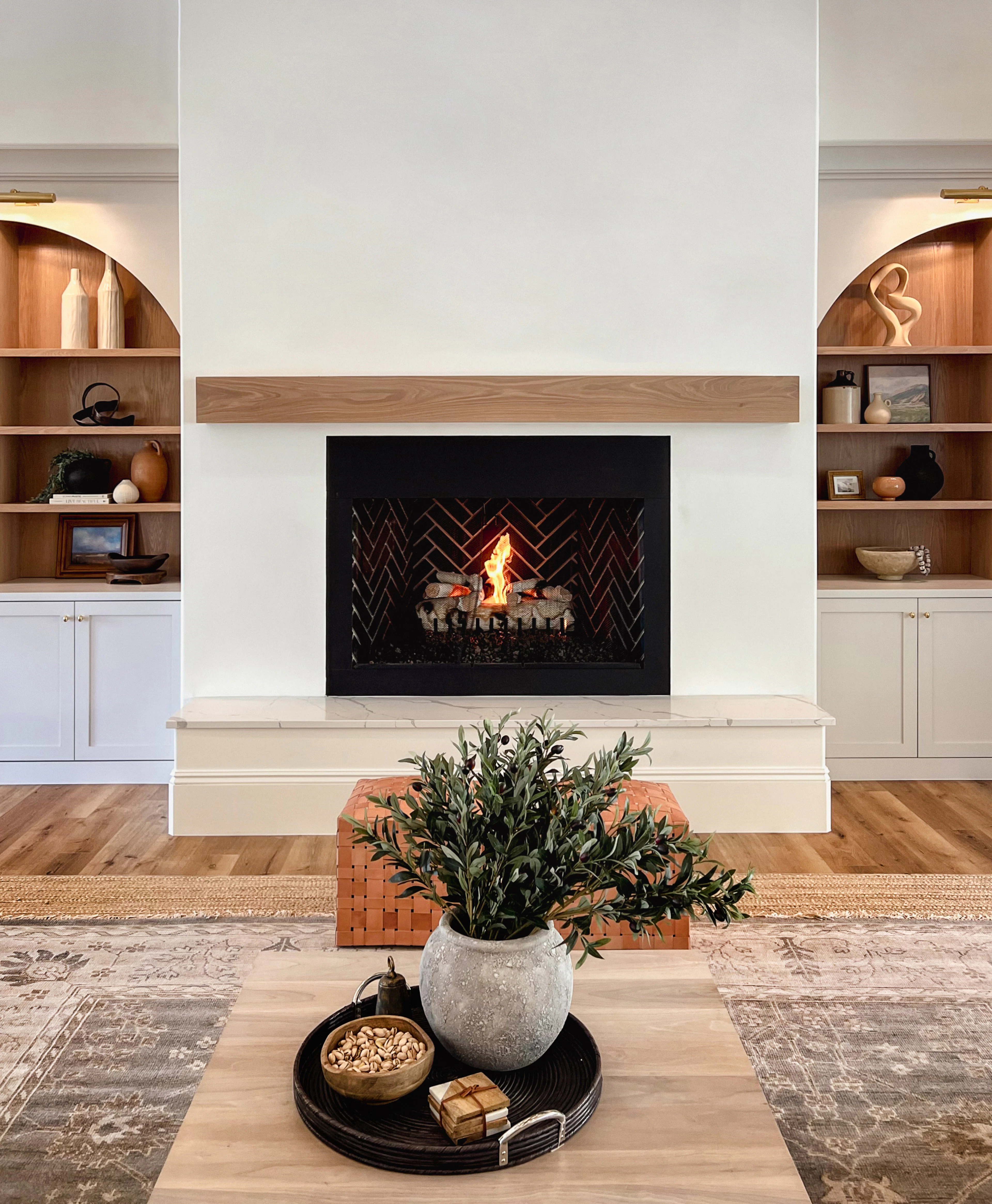 Fireplace flanked by built-in alcove shelving