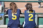 a couple of girls in sports jerseys
