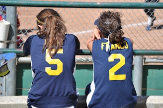 a couple of girls in sports jerseys