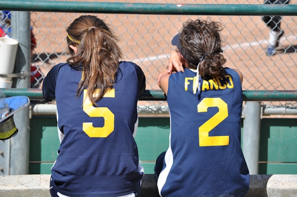 a couple of girls in sports jerseys