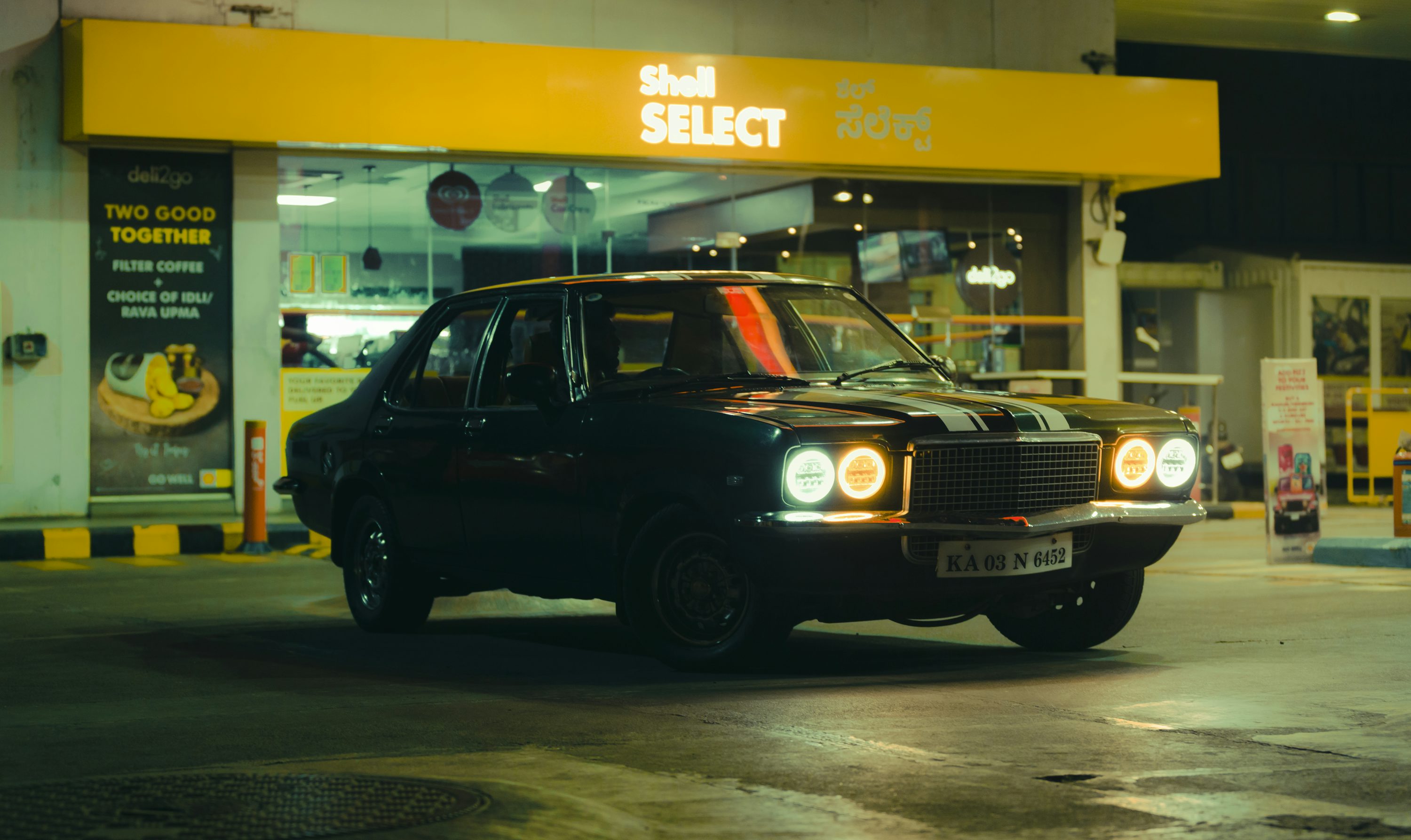 a black car parked in front of a store