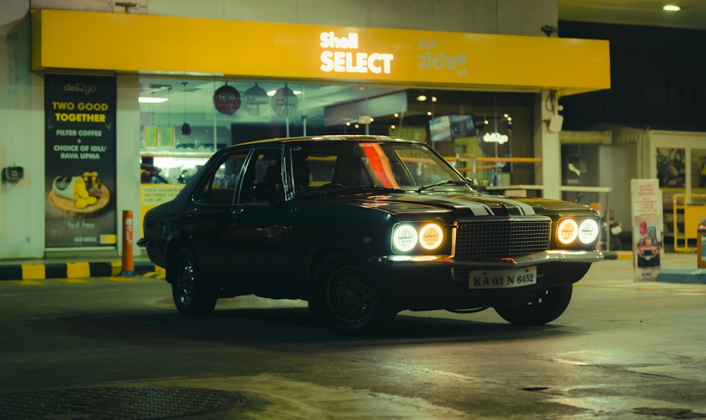 a black car parked in front of a store