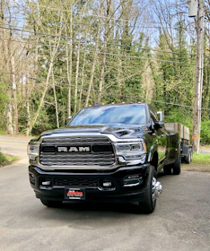 a black truck parked on a road