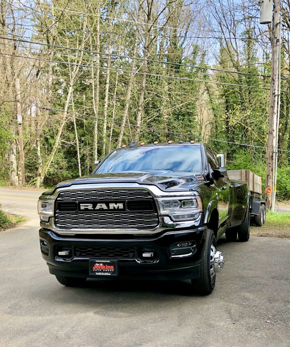 a black truck parked on a road