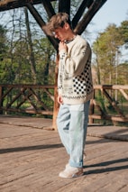a man standing on a wooden bridge