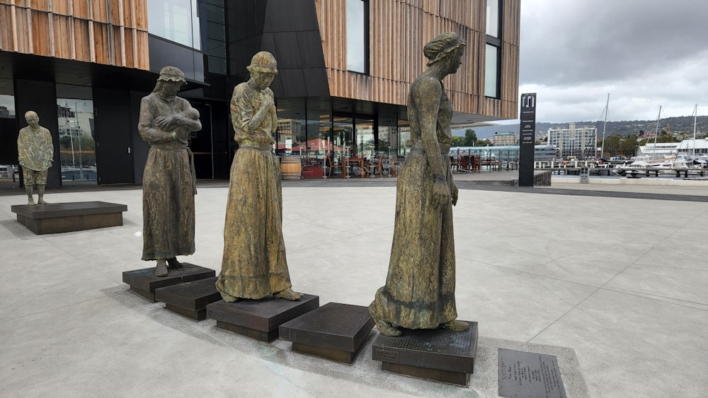 a group of statues in front of a building