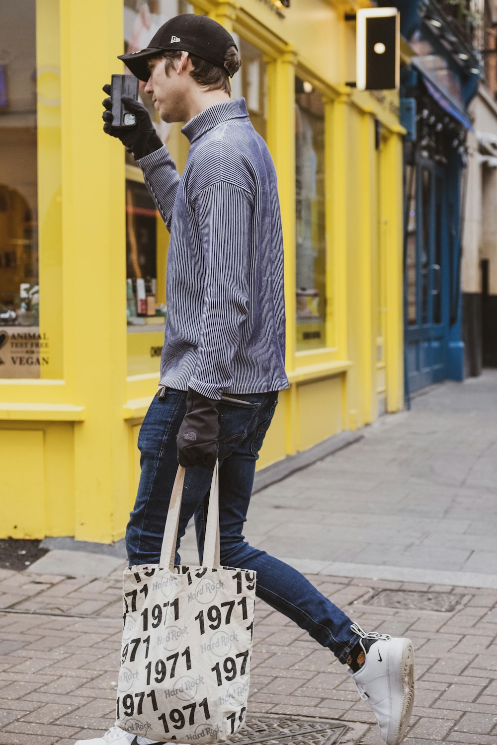 a person wearing a hat and holding a sign