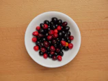 Close-up of fresh goji berries in a rustic wooden bowl
