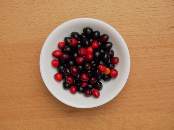 Close-up of fresh goji berries in a rustic wooden bowl
