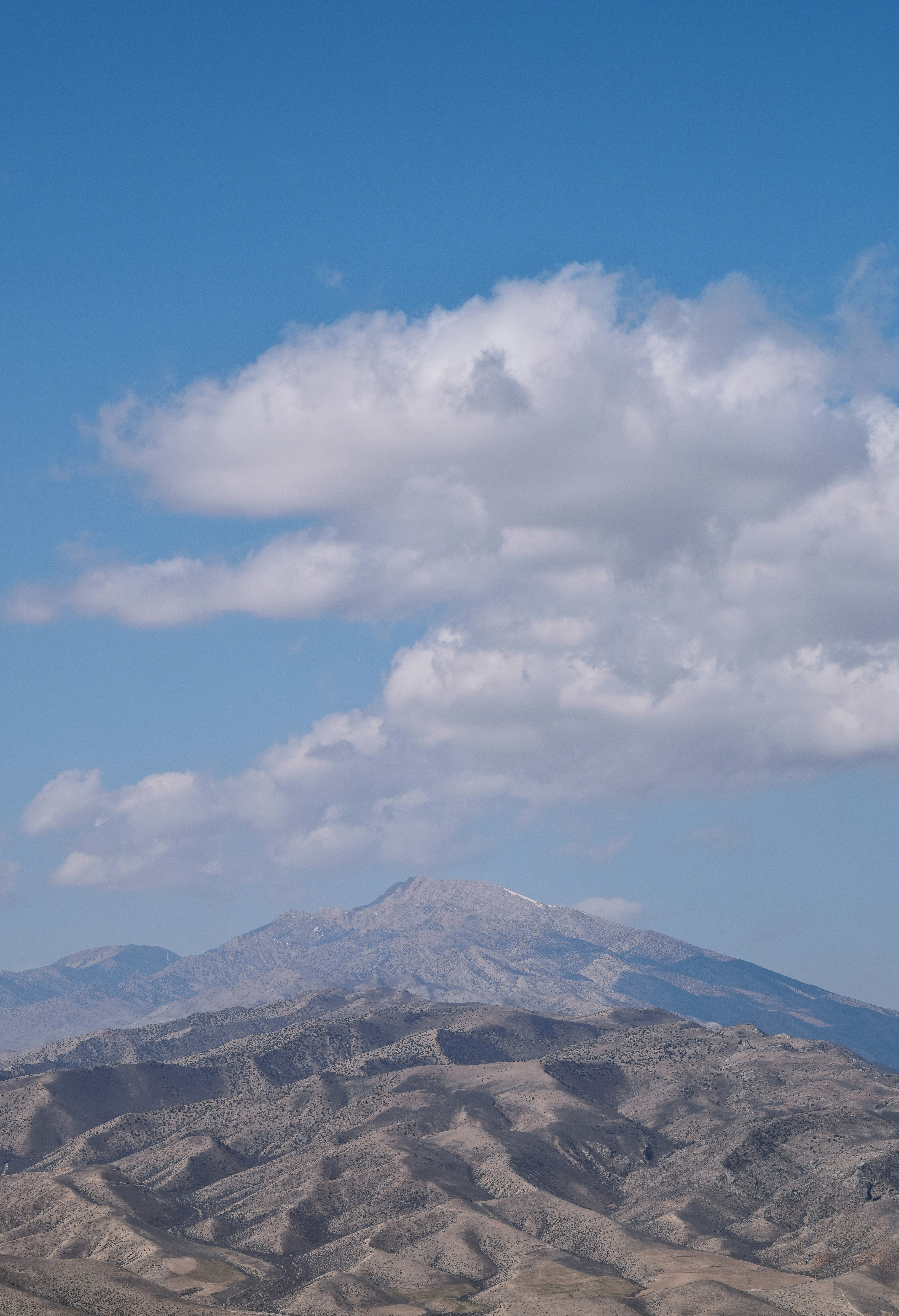 a mountain with a cloudy sky