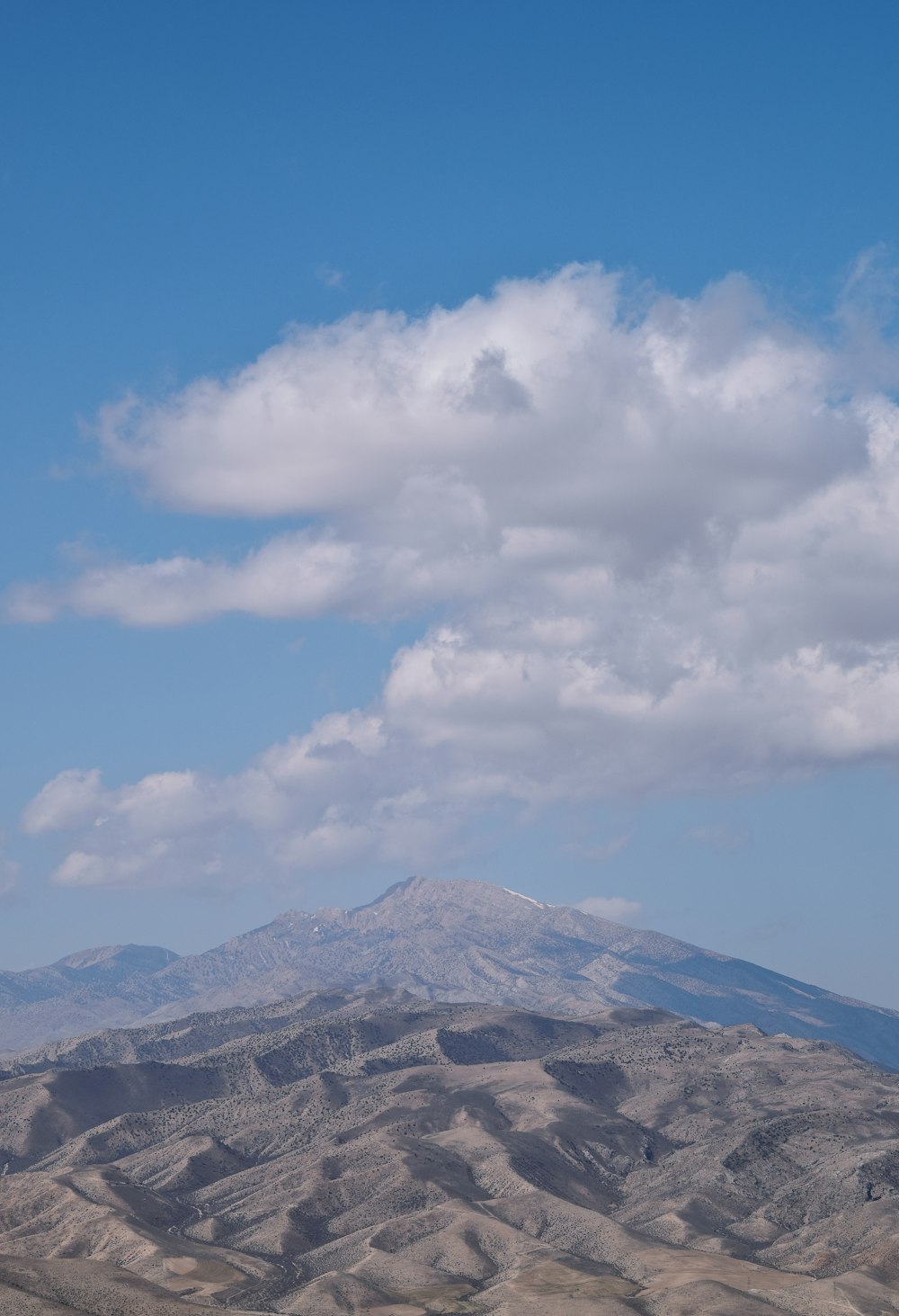 a mountain with a cloudy sky