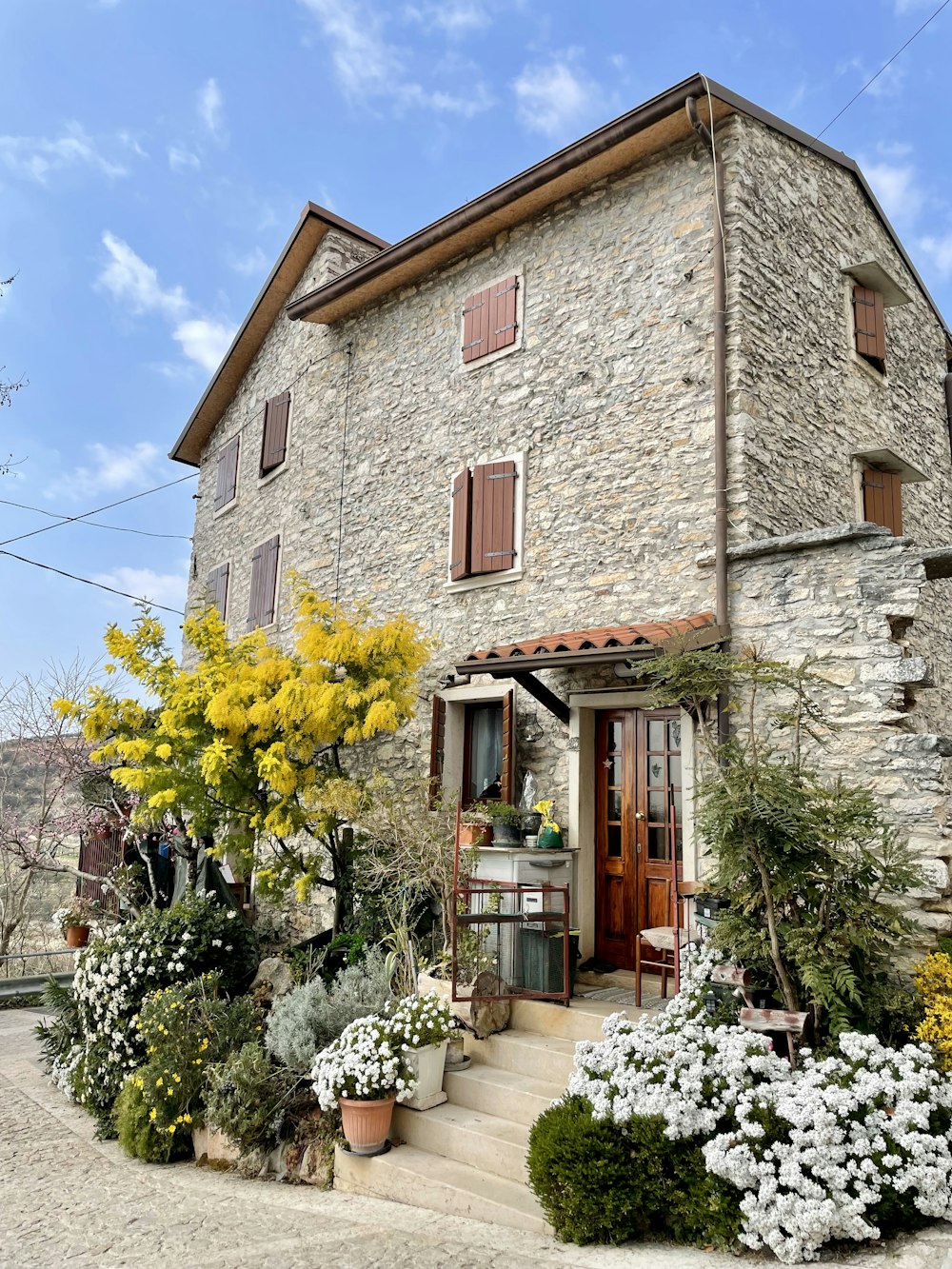 a stone building with a garden in front of it