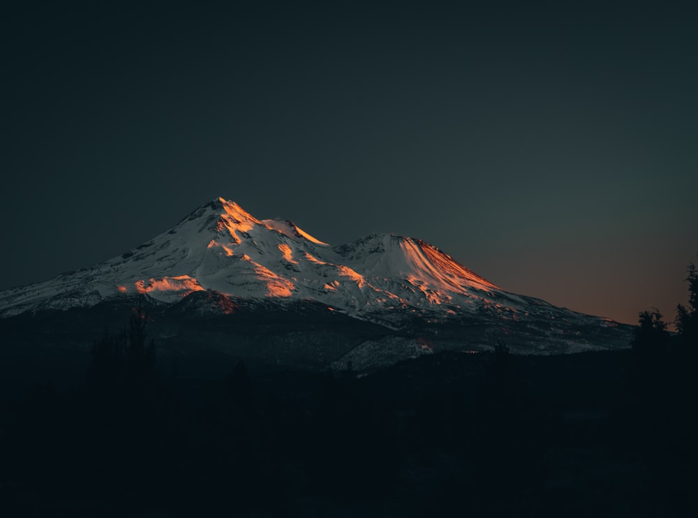a snowy mountain at night