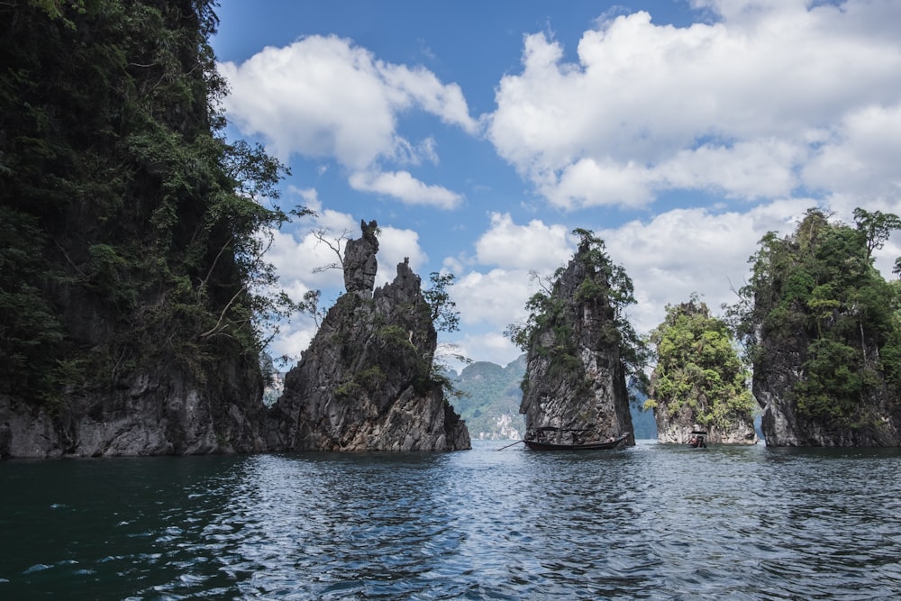 a body of water with trees and rocks on the side