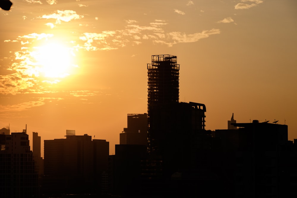 a city skyline with the sun setting