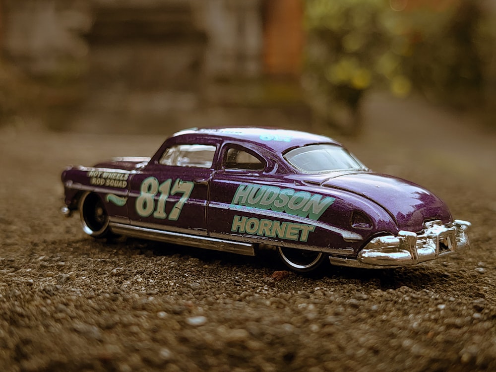 a race car driving on a dirt road