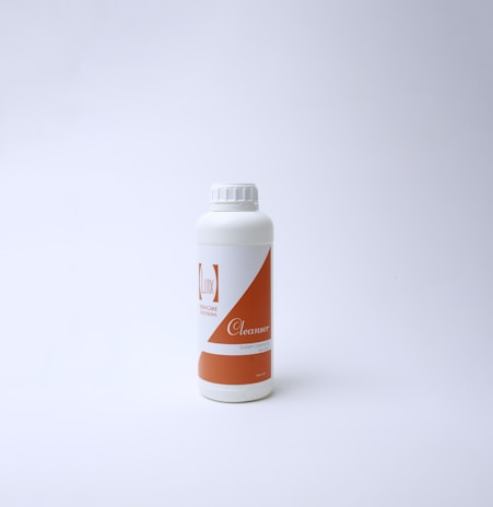 A gentle splash of water over nlcc's facial cleansers in minimalist white packaging.