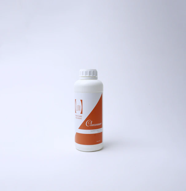 Close-up of a clean, minimalist bottle of faced front cleanser with scientific ingredient labels.