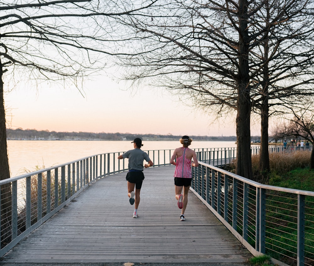 a couple jogging on a bridge