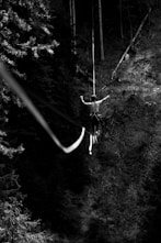 a person from a rope in the woods