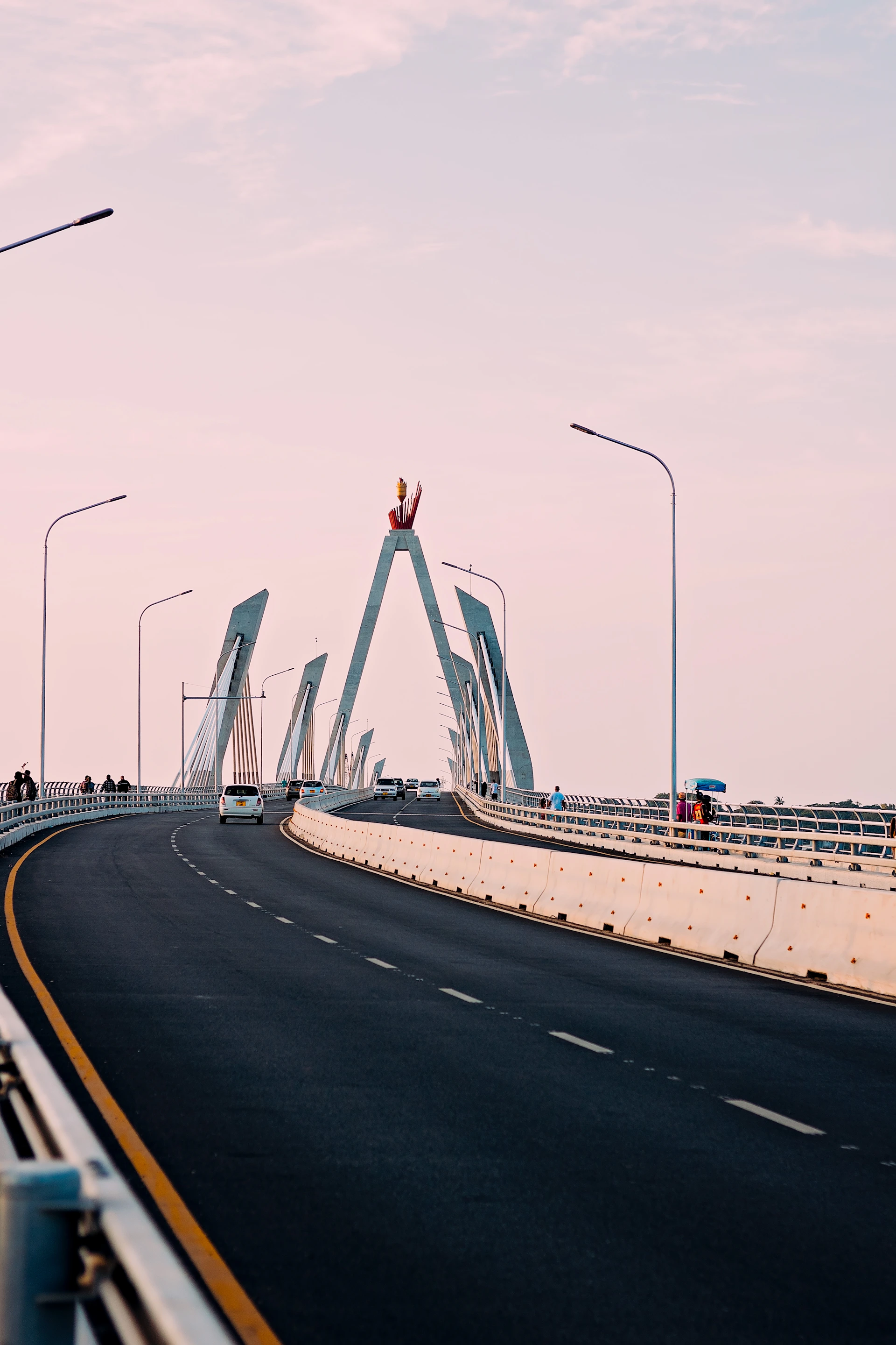 a bridge with a roller coaster in the background