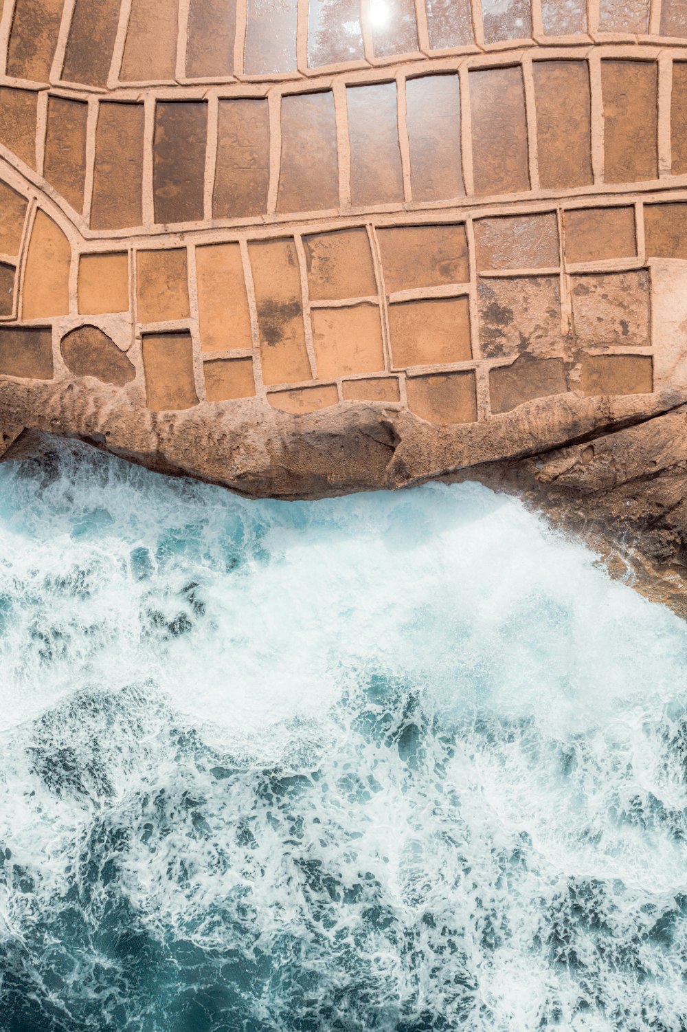 a waterfall in front of a brick building