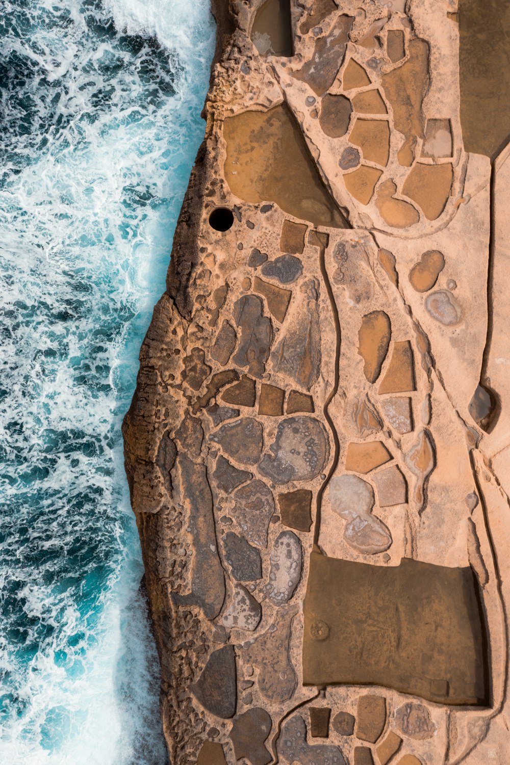 a stone wall with a hole in it