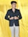 a person standing in front of a yellow curtain