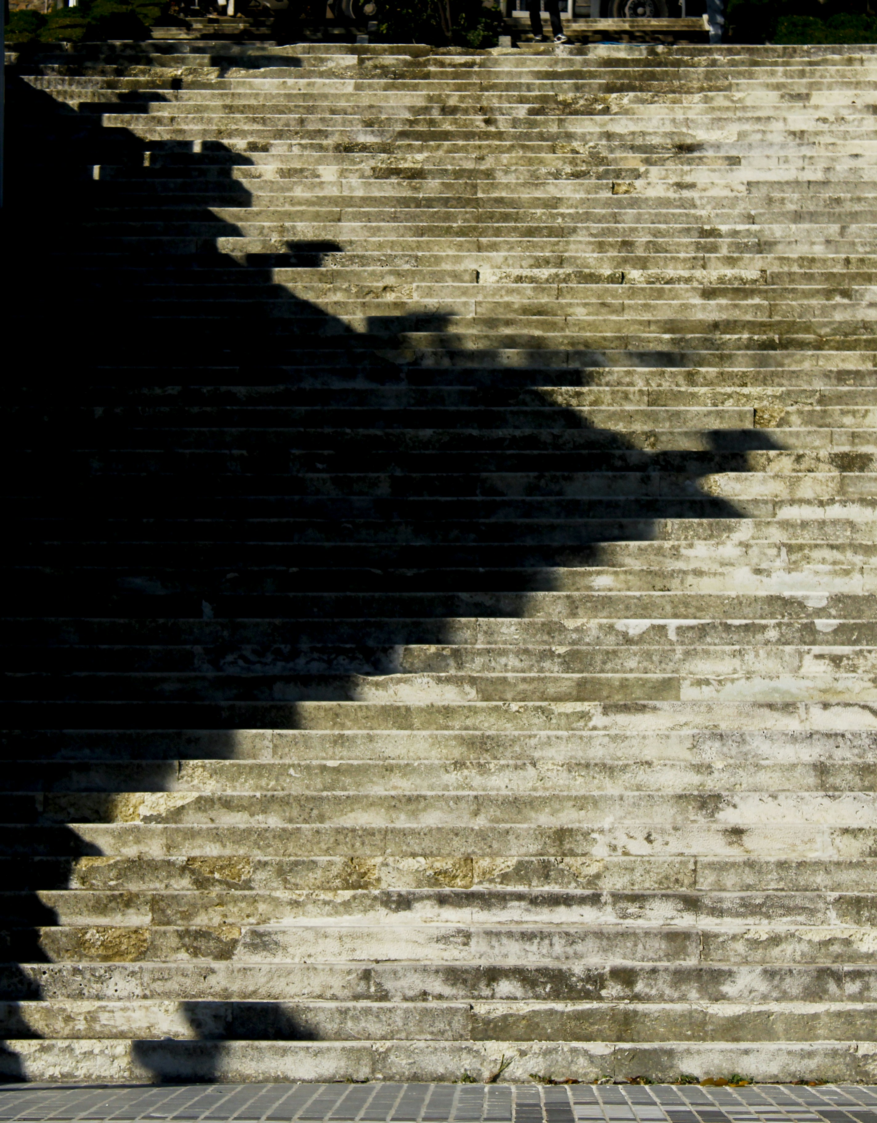 a shadow of a person on a brick wall