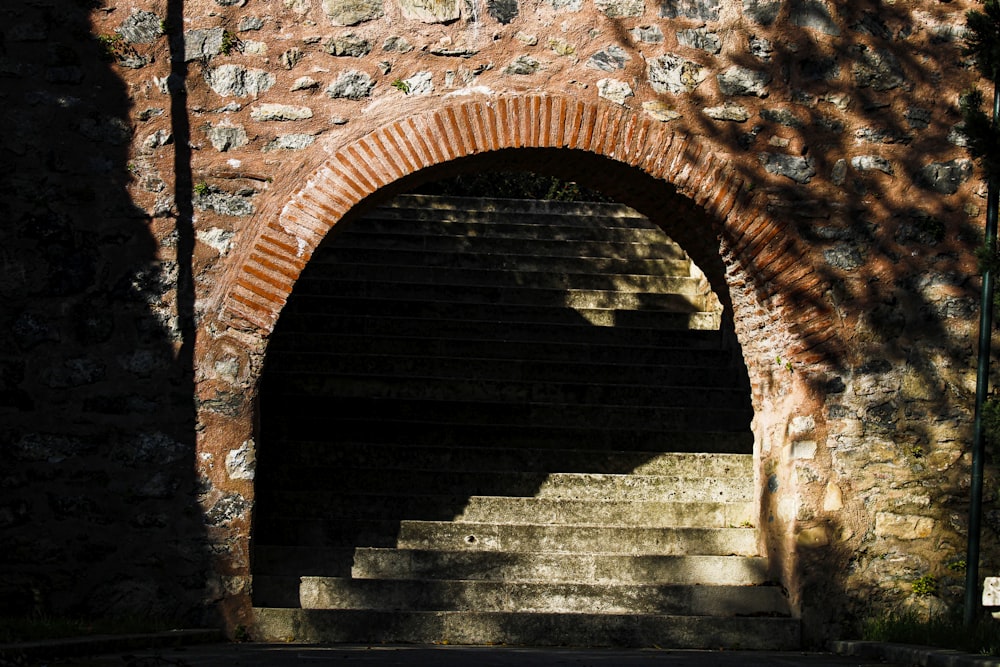 a stone staircase in a stone tunnel