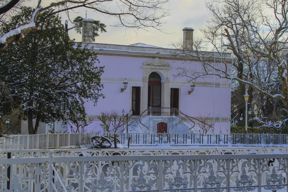 a white house with a white picket fence and a white picket fence